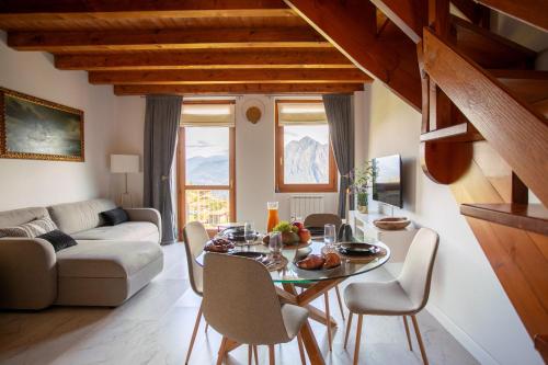 a living room with a table and chairs at L'angolo di Fonteno in Fonteno