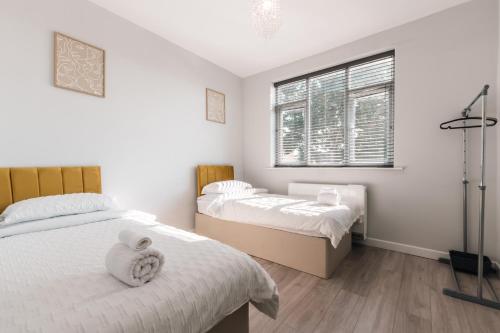 a bedroom with two beds and a window at Shirley 2 Bed Apartment in Southampton