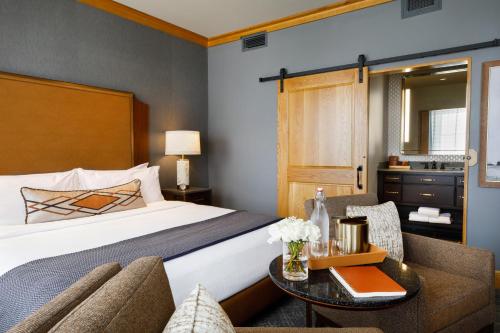 a hotel room with a bed and a table at The Barfield, Autograph Collection in Amarillo