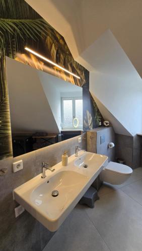 a bathroom with a sink and a toilet at Luxus Ferienwohnung Himmel und SPA mit privater Sauna und Wellnessdusche inkl Wifi und Parkplatz für 4Personen in Muhr amSee