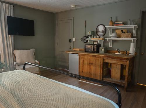 a room with a bed and a table with a clock at LMI -15- Laurel Falls Room: Summers Night in Lookout Mountain