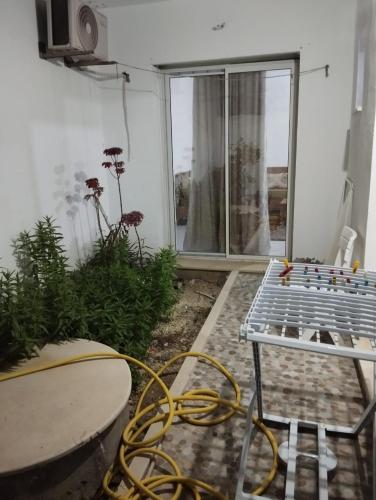 a view of a patio with a table and a window at maison fella in Kelibia