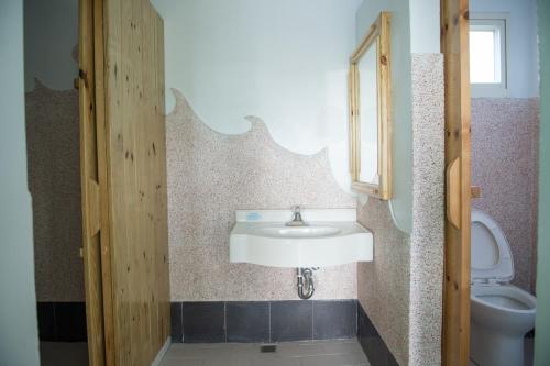 a bathroom with a sink and a toilet at Country Lane in Checheng