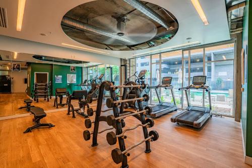 a gym with treadmills and exercise equipment in a building at Lovely 1BD - Central Downtown - Gym, Pool, Parking in Phoenix