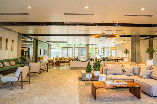 a living room with a couch and a table at Lovely 1BD - Central Downtown - Gym, Pool, Parking in Phoenix