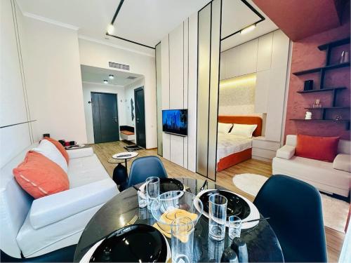 a living room with a glass table and a bed at Amber Nest Tsaghkadzor in Tsaghkadzor