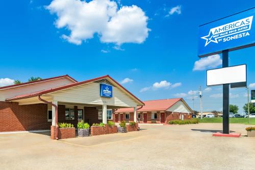 a store with a sign in front of it at Americas Best Value Inn and Suites Siloam Springs in Siloam Springs