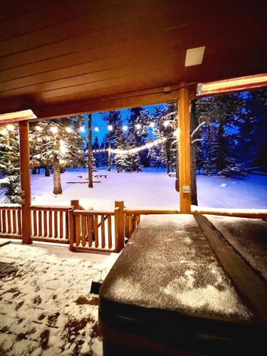 a porch with a view of a snow covered yard at Three level cabin with Hot Tub in Duck Creek Village