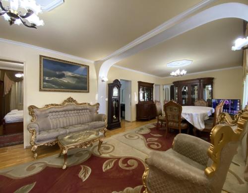 a living room with a couch and a table at Lux Villa Yerevan in Yerevan