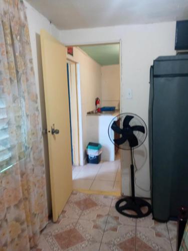 a room with a room with a door and a room with a kitchen at MaFlo Arms in Belize City