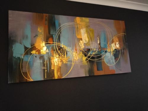 a painting hanging on a wall at Gracious Beauty in Bloemfontein