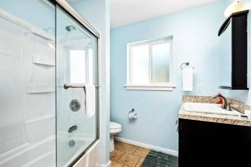 a bathroom with a shower and a sink and a toilet at Ocean Oasis in Rockaway Beach