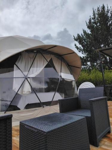 a tent with a table and chairs in front of it at Sweet Forest- Domo Luna in Punilla