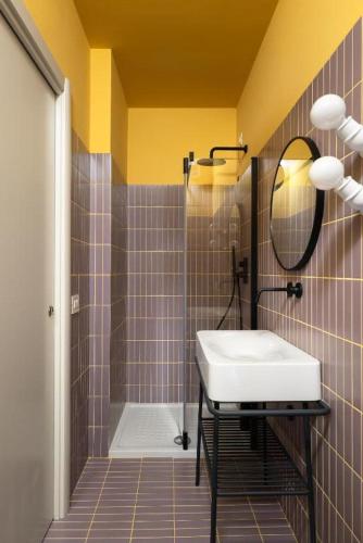 a bathroom with a sink and a mirror at In Piazza BnB in San Salvo