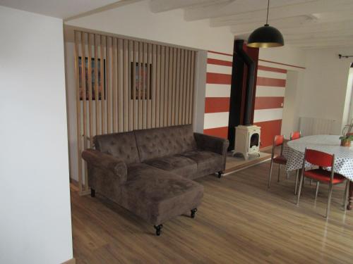 a living room with a couch and a table at Le Loft de l'Abbaye in Saint-Savin-sur-Gartempe
