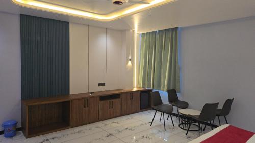 a room with a podium with chairs and a table at Premvakita restaurant and hotel in Ratlām