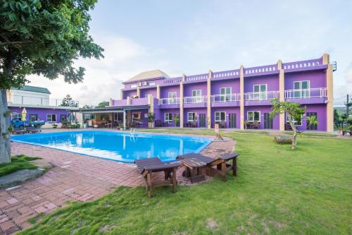 a large building with a swimming pool in front of it at Country Lane in Checheng