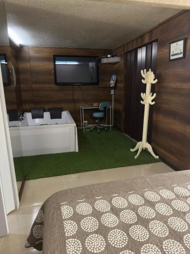 a bedroom with a bed and a tv on the wall at VIP planet urban Room in Armenia