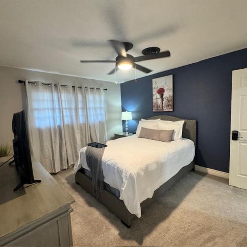 a bedroom with a bed and a ceiling fan at Raider Retreat-Your TTU Basecamp in Lubbock