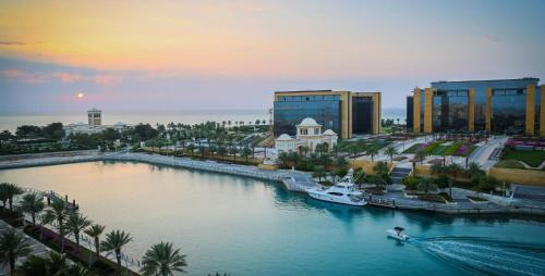 a city with a river with a boat in it at مارينا موج البحر غرفتين اطلاله بحريه عوائل فقط Marina sea waves in King Abdullah Economic City