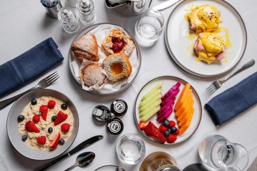 a white table with plates of food on it at W Sydney in Sydney