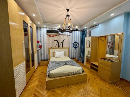 a small bedroom with a bed and a mirror at ALEX HOMES - Gleem Luxury Apartments with Direct Sea View in Alexandria