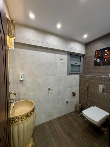 a bathroom with a sink and a toilet at ALEX HOMES - Gleem Luxury Apartments with Direct Sea View in Alexandria