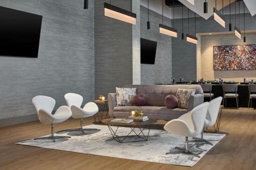 a living room with a couch and chairs and a bar at The Westin Charlotte in Charlotte