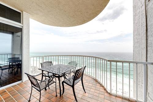 a balcony with a table and chairs and the ocean at Hidden Dunes 1706 in Destin