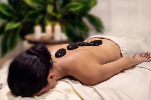 a woman laying on a bed with sunglasses on her back at The Buenaventura Golf & Beach Resort, Autograph Collection in Playa Blanca