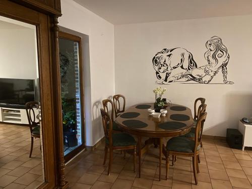 a dining room with a table and chairs and a tv at Perk25A in Steenokkerzeel