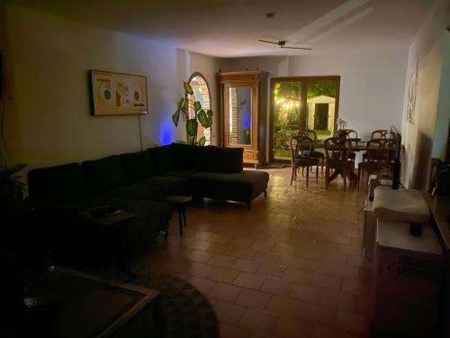 a living room with a couch and a dining room at Perk25A in Steenokkerzeel