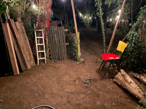 a red chair sitting in a yard at night at Perk25A in Steenokkerzeel