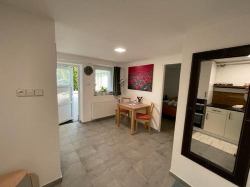 a living room with a table and a kitchen at Astoria Lednice in Lednice
