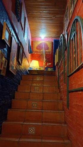 a staircase in a building with a light at the top at Estancia Hostel in Colonia del Sacramento
