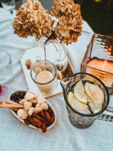 a table with a vase of flowers and a bowl of food at La Rondine in Gravedona