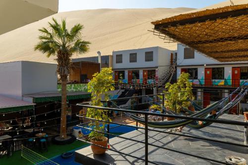an empty playground with a slide and palm trees at Wild Rover Huacachina in Ica