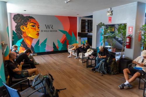 a group of people sitting in chairs in a room at Wild Rover Huacachina in Ica