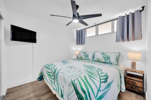 a bedroom with a bed and a ceiling fan at Hale Kai O'Kihei 309 in Kihei