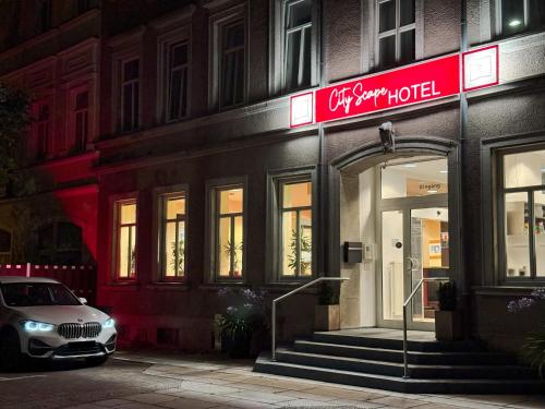 a car parked in front of a store with a red sign at CityScape Hotel in Chemnitz