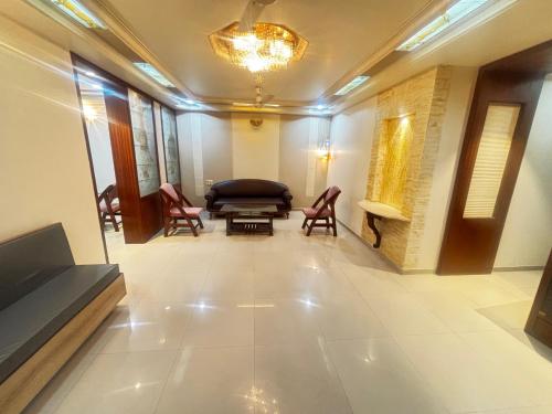 a hallway with a waiting room with chairs and a couch at JK Rooms 149 Thakur Galaxy in Nagpur