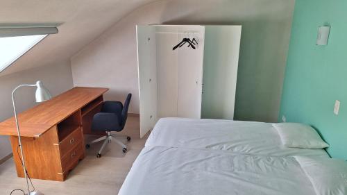 a bedroom with a desk and a bed and a desk and chair at Peaceful Countryside Escape for Leisure or Work, Near Brussels in Dilbeek