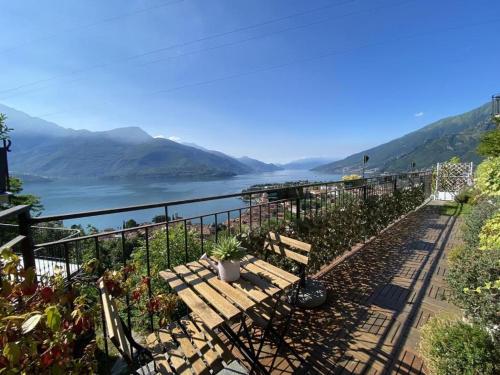 a bench with a view of the water and mountains at La Rondine in Gravedona