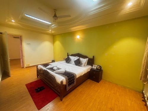 a bedroom with a bed and a red rug at JK Rooms 149 Thakur Galaxy in Nagpur