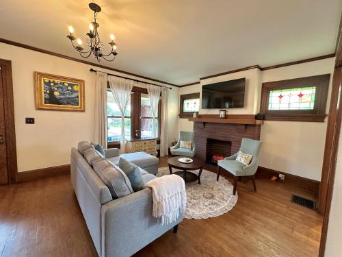 a living room with a couch and a fireplace at The Dayton DreamHouse in Dayton