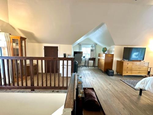 a room with a bed and a tv and a balcony at The Dayton DreamHouse in Dayton