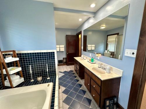 a bathroom with a tub and a sink and a bath tub at The Dayton DreamHouse in Dayton