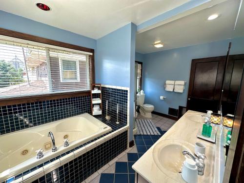 a bathroom with a tub and a sink at The Dayton DreamHouse in Dayton