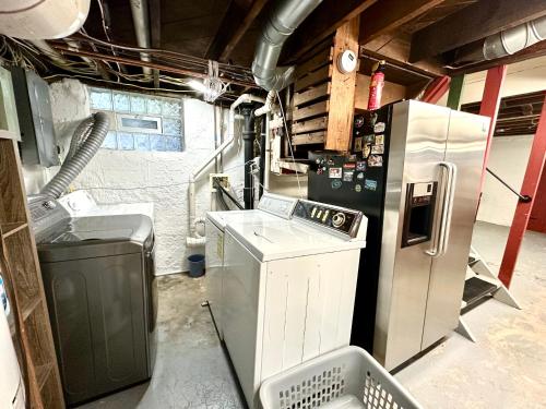 a kitchen with a refrigerator and a washer and dryer at The Dayton DreamHouse in Dayton