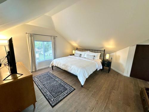 a bedroom with a bed and a large window at The Dayton DreamHouse in Dayton